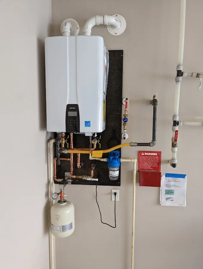 Professional plumber installing copper piping in a Hodgenville home